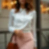 Elegant long sleeve white blouse styled with a chic skirt