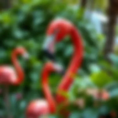 A vibrant garden featuring large pink flamingo statues amidst lush greenery.