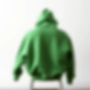 Minimalist Fashion Statement Stylish green hoodie draped over a minimalist chair