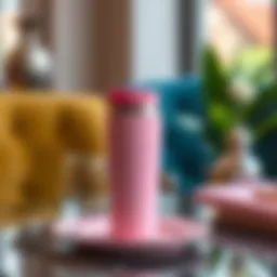 Elegant pink travel coffee mug on a stylish table setting