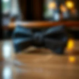 Elegant sparkly black bow tie displayed on a polished surface