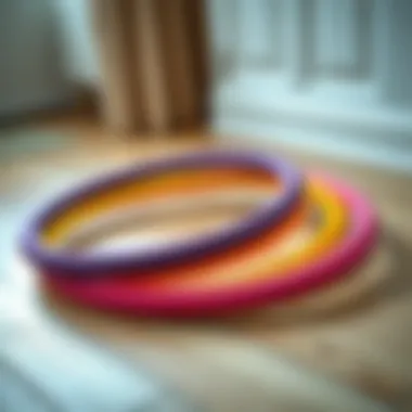 Vibrant Colors of Padded Hula Hoops A colorful padded hula hoop resting on a wooden floor.